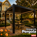 Modern black aluminum louvered pergola installed in an Old Towne Orange Victorian home backyard with rose garden, brick pathways, and vintage 1900s home at golden hour